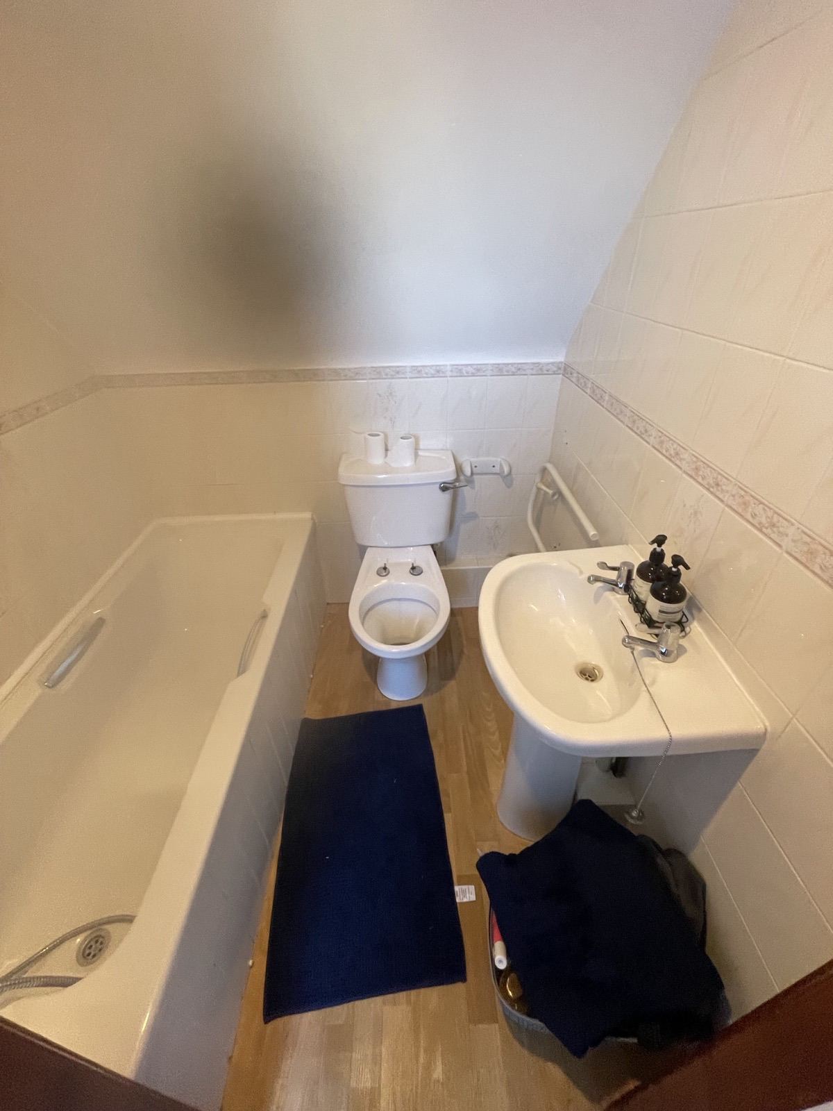 Bathroom with a standard bath before renovation work