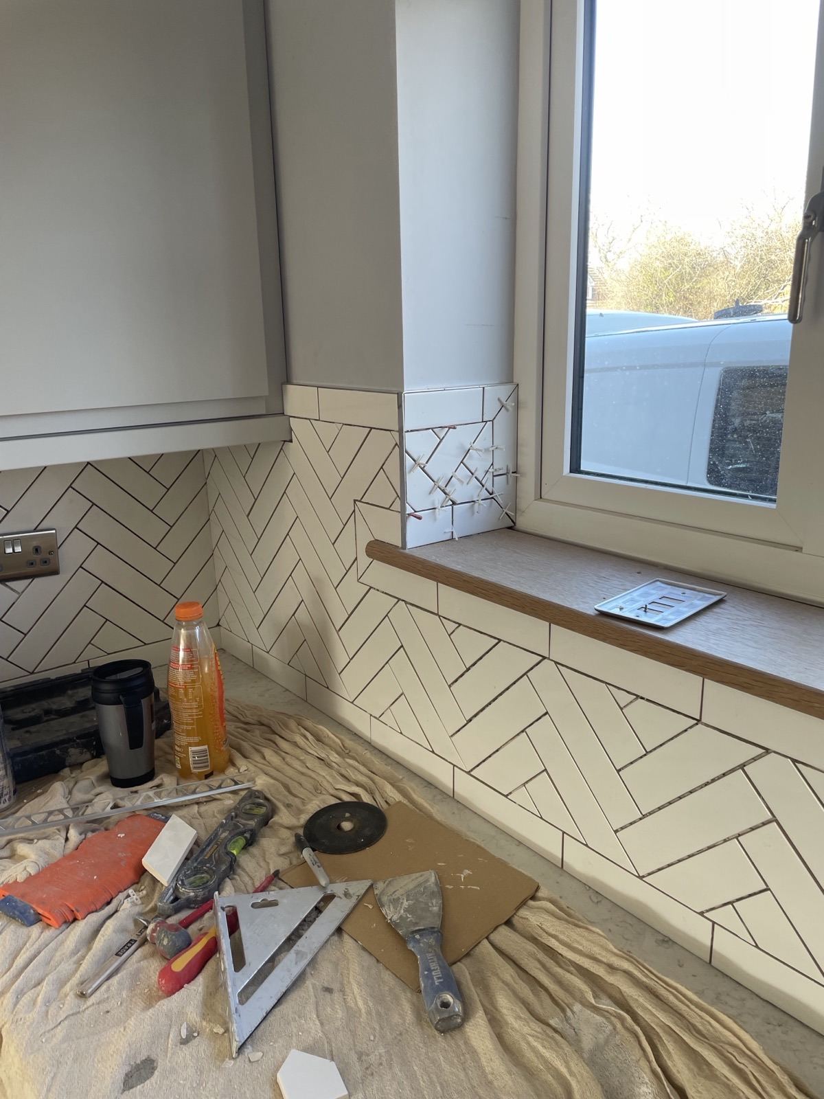 White herringbone tiling around a window