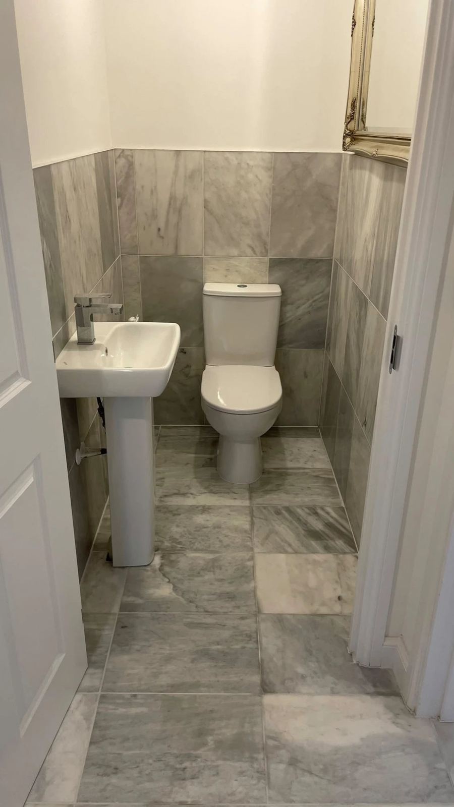 Cloakroom with natural marble wall and floor tiling