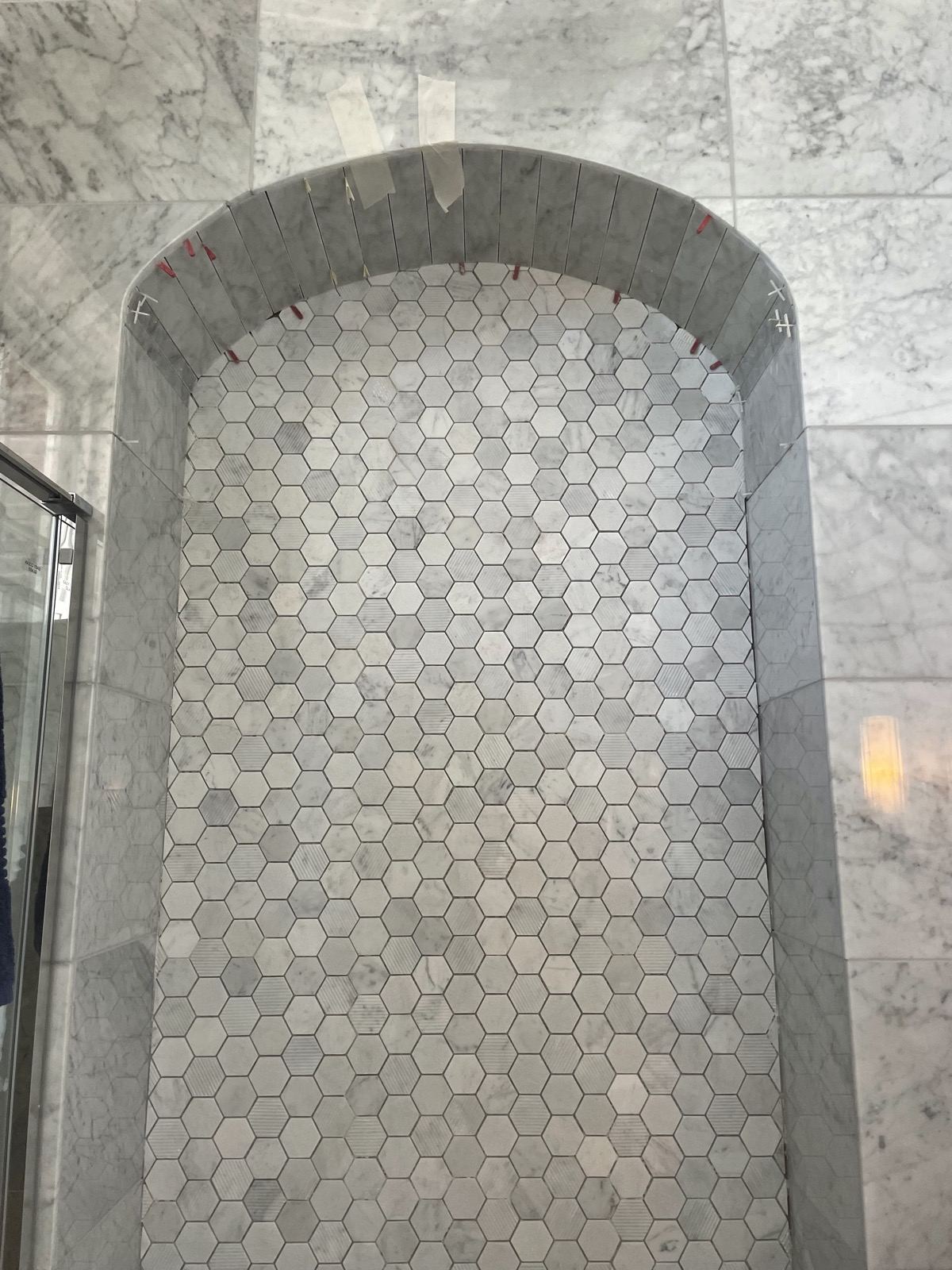 Hexagon mosaic shower wall with a niche